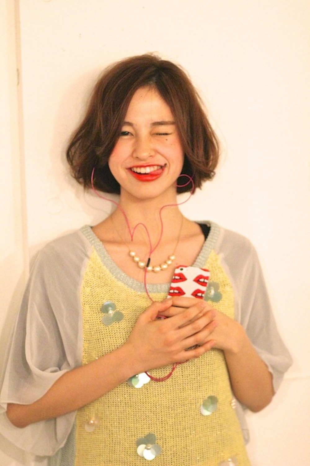 舌だして笑うボブスタイルの女性